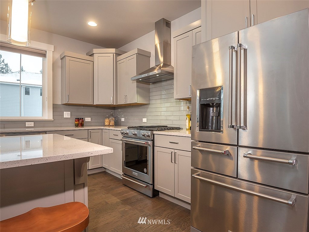 17 197th Place Southwest Bothell, WA 98012 - Photo 5 of 34 a kitchen with stainless steel appliances granite countertop a sink stove and refrigerator