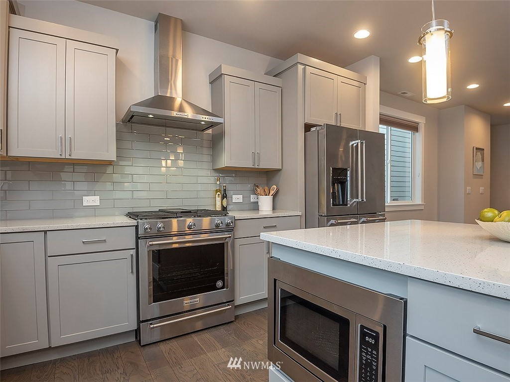 17 197th Place Southwest Bothell, WA 98012 - Photo 7 of 34 a kitchen with stainless steel appliances a stove a sink and a refrigerator