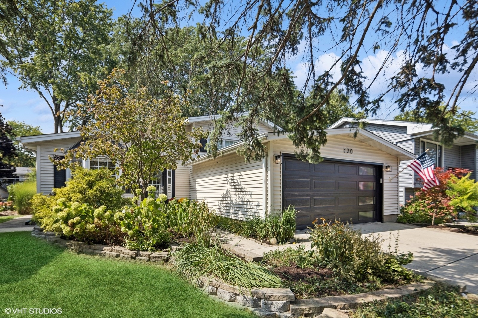 120 North Lambert Road Glen Ellyn, IL 60137 - Photo 2 of 30 a front view of a house with a garden