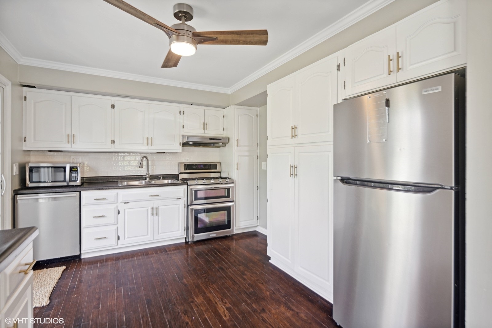 120 North Lambert Road Glen Ellyn, IL 60137 - Photo 7 of 30 a kitchen with a refrigerator a sink and white cabinets