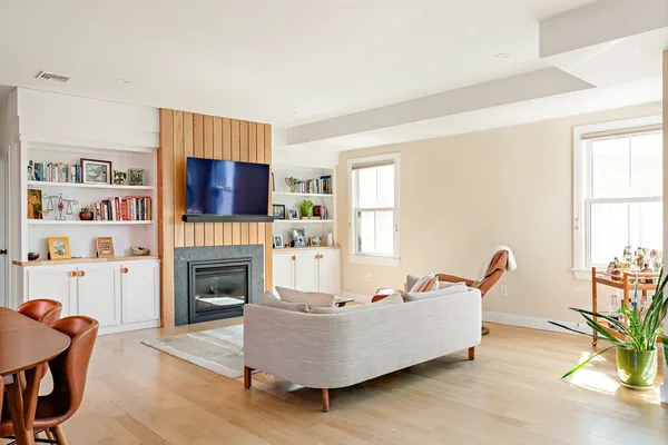 a living room with furniture and a fireplace