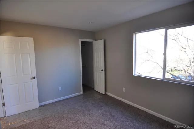 a kitchen with cabinets and wooden floor