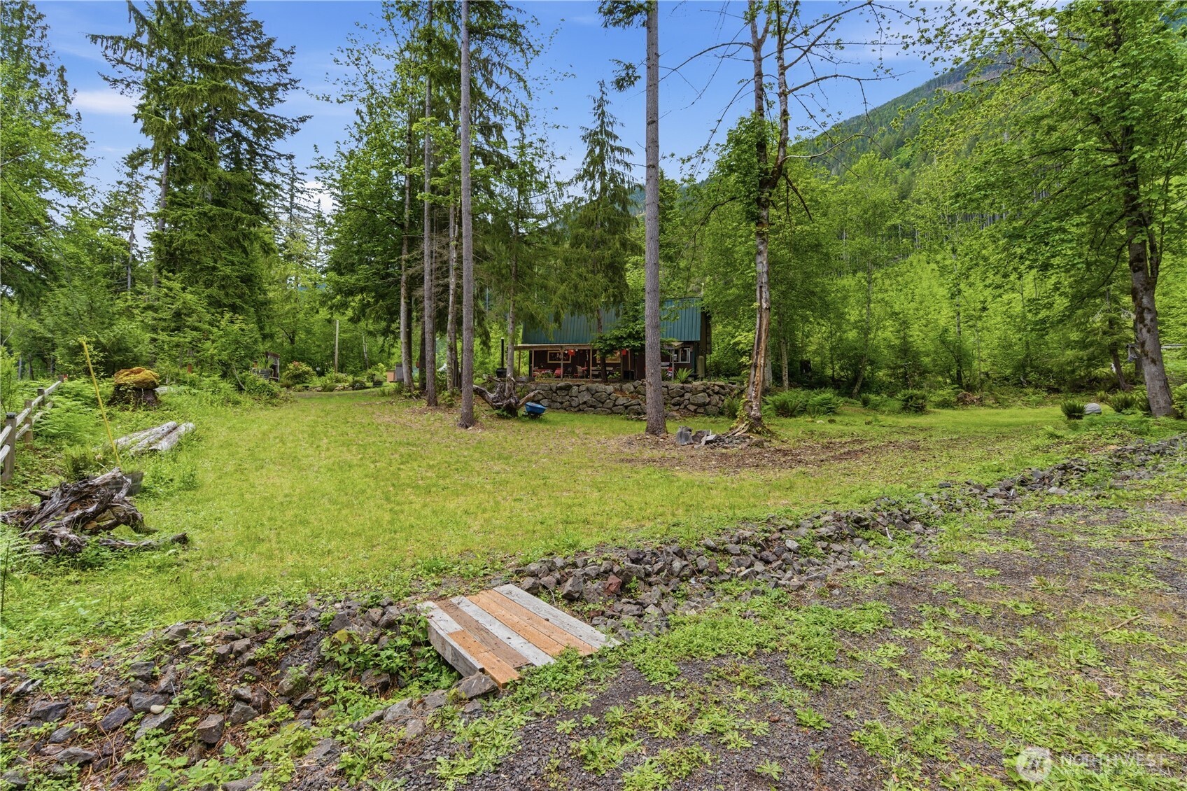 3320 Duckabush Road Brinnon, WA 98320 - Photo 26 of 38 a backyard of a house with lots of green space