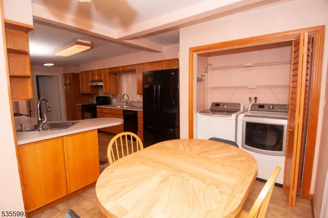 a large white kitchen with a stove a sink and a refrigerator
