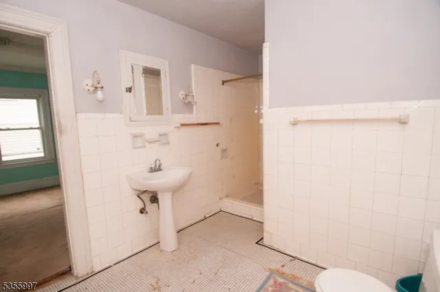 a bathroom with a sink a toilet and mirror