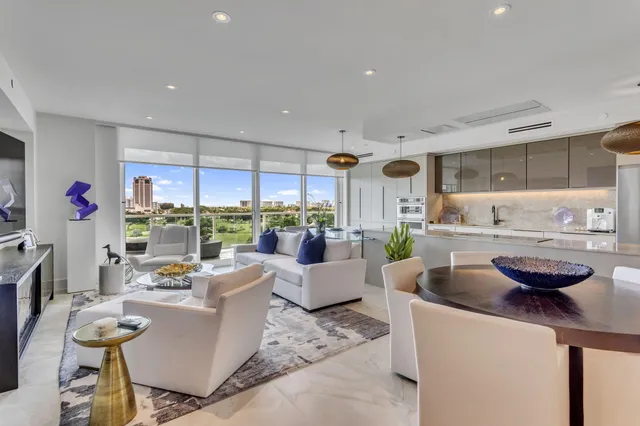 a living room with furniture and a floor to ceiling window