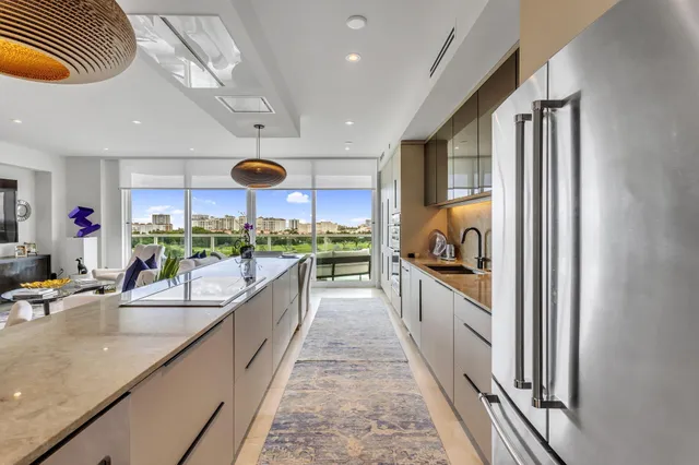 a kitchen with stainless steel appliances kitchen island granite countertop a sink and cabinets