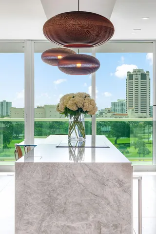 a kitchen with a dining table chairs and white stainless steel appliances