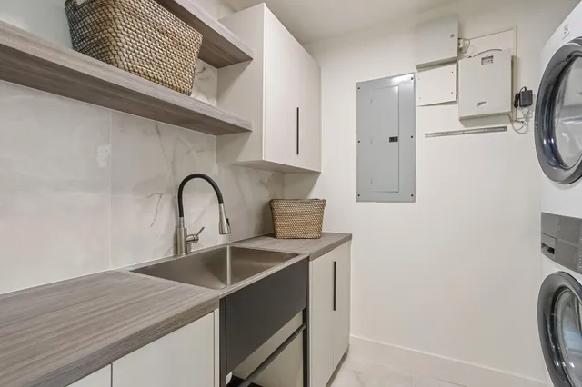 a view of a patio with couches potted plants and wooden floor
