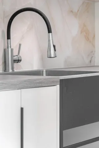 a living room with furniture a floor to ceiling window and a kitchen