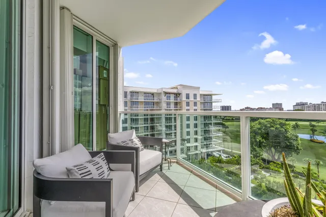 a view of a balcony with lake view and a potted plant