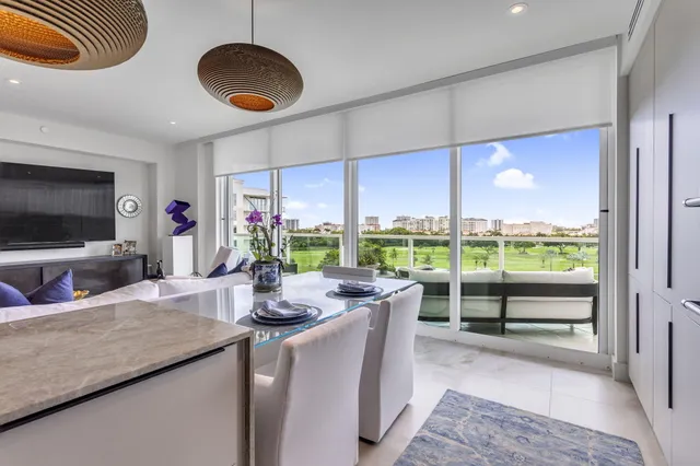 a dining room with furniture a window and a flat screen tv