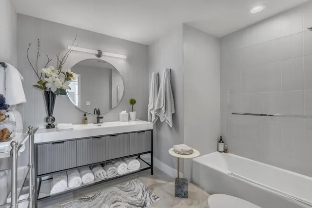 a bedroom with a bed a chandelier and a painting on the wall