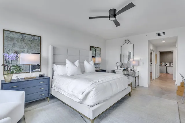 a bedroom with two beds and large window