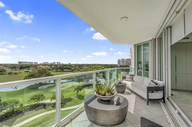 a balcony with furniture and a potted plant
