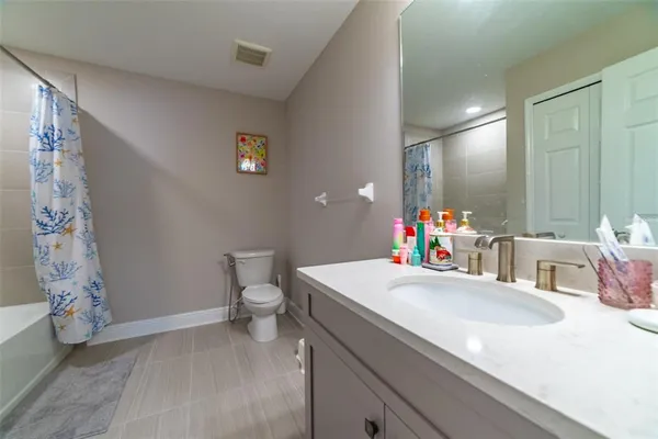 a kitchen with granite countertop a sink stainless steel appliances and cabinets