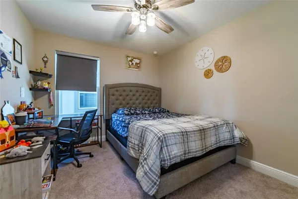 a bed sitting in a bedroom next to a window