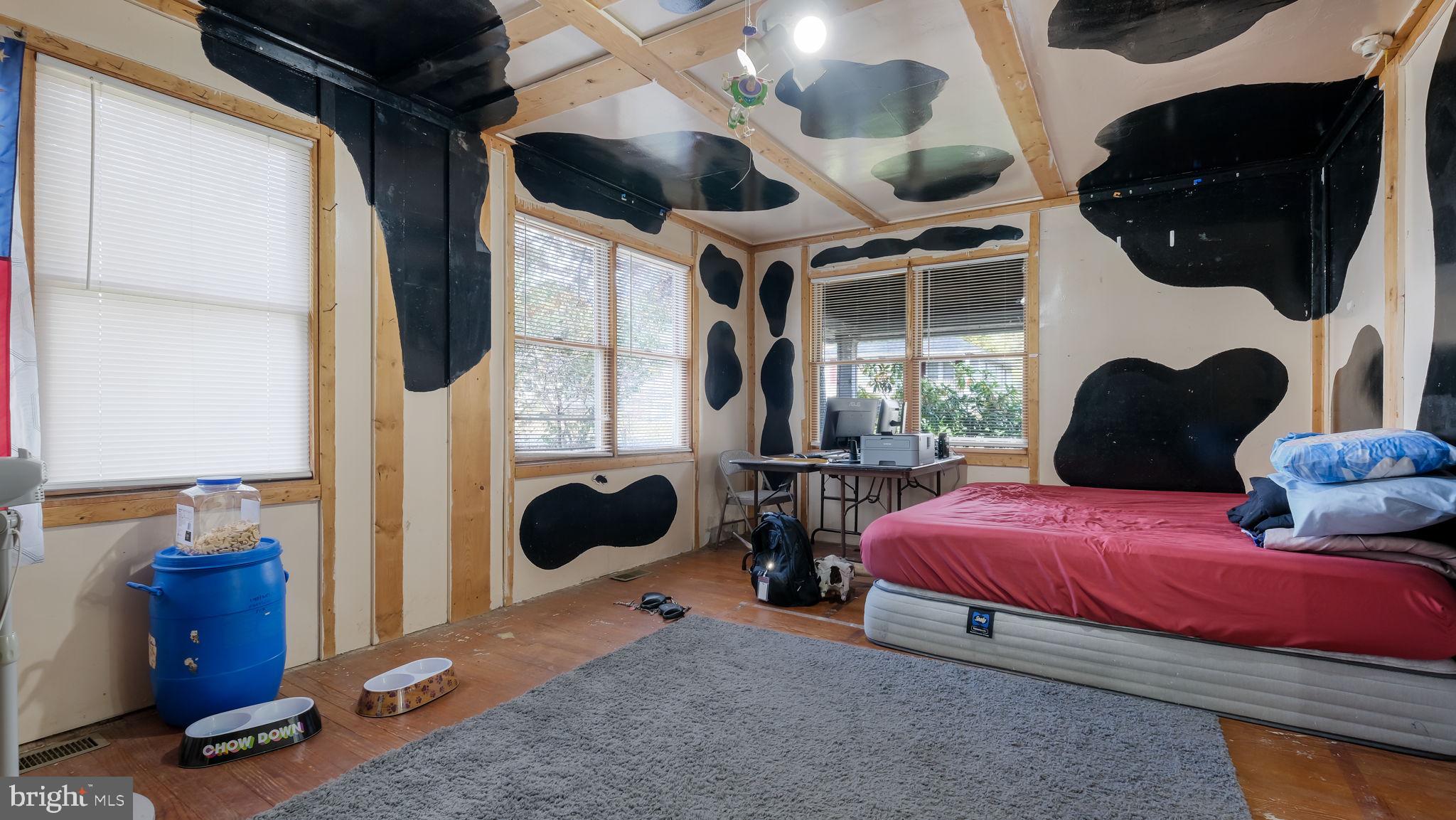 2943 East Walnut Street Colmar, PA 18915 - Photo 12 of 27 a bedroom with a bed a flat screen tv and balcony view