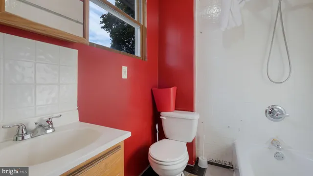 a white toilet sitting next to a bathroom sink