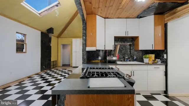 a kitchen with a stove a sink and a refrigerator