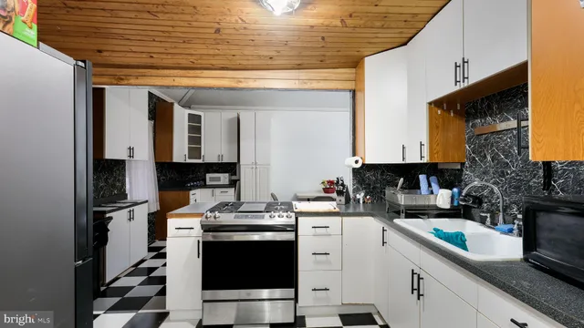 a kitchen with a stove a sink and a refrigerator