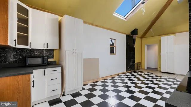 a kitchen with a refrigerator and cabinets