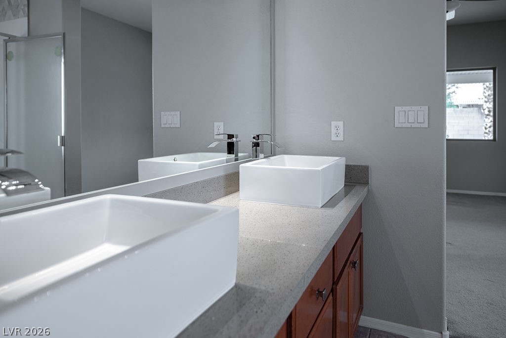 3591 Driving Range Street Las Vegas, NV 89122 - Photo 42 of 79 This bathroom features contemporary vessel sinks and spacious vanity with ample storage.