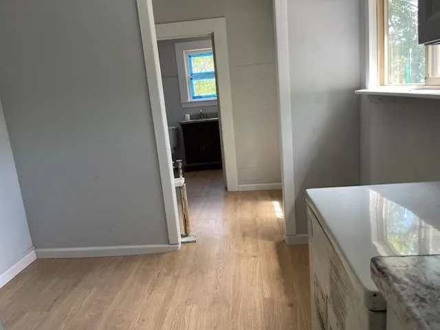 an entryway with a window and wooden floor