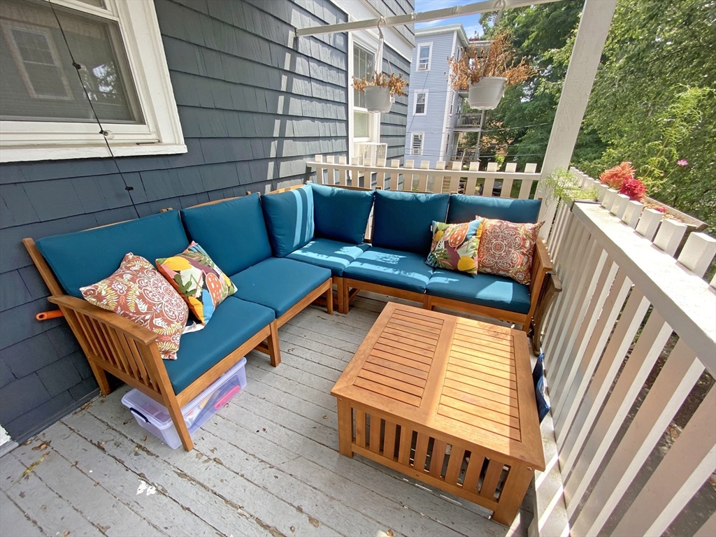 159 Forest Hills Street, Unit 2 Boston, MA 02130 - Photo 19 of 24 a blue bench sitting in front of a building