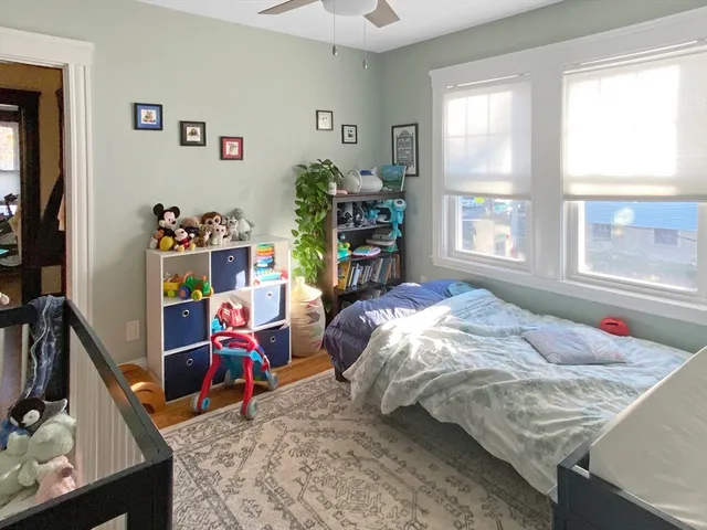 a bed sitting in a bedroom next to a window