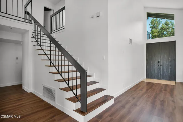a view of entryway with wooden floor and stairs