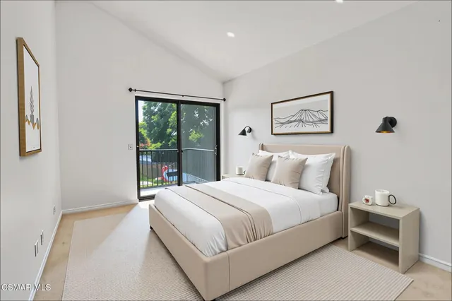 a bedroom with a large bed and a window