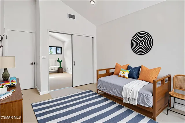 a bedroom with a bed and a rug