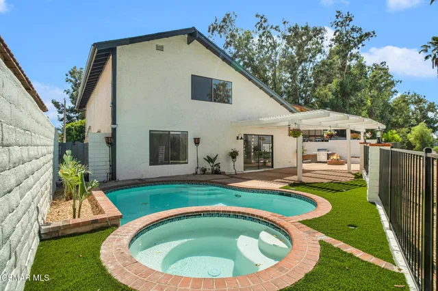 a view of a house with swimming pool and porch
