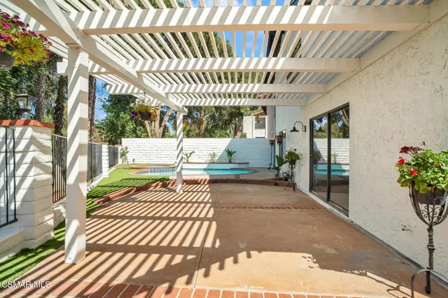 a view of a porch with a table and chairs