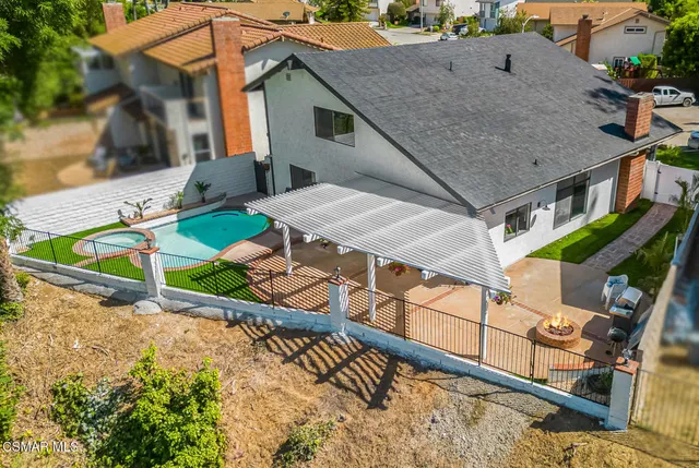 an aerial view of a house with swimming pool and porch