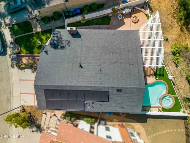 an aerial view of a house with a swimming pool