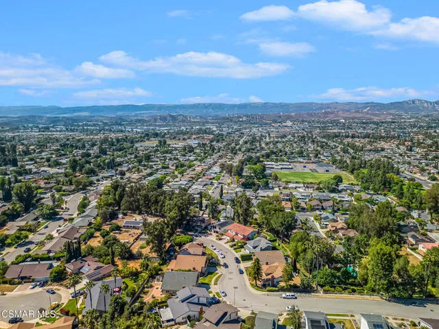 an aerial view of residential houses with city view