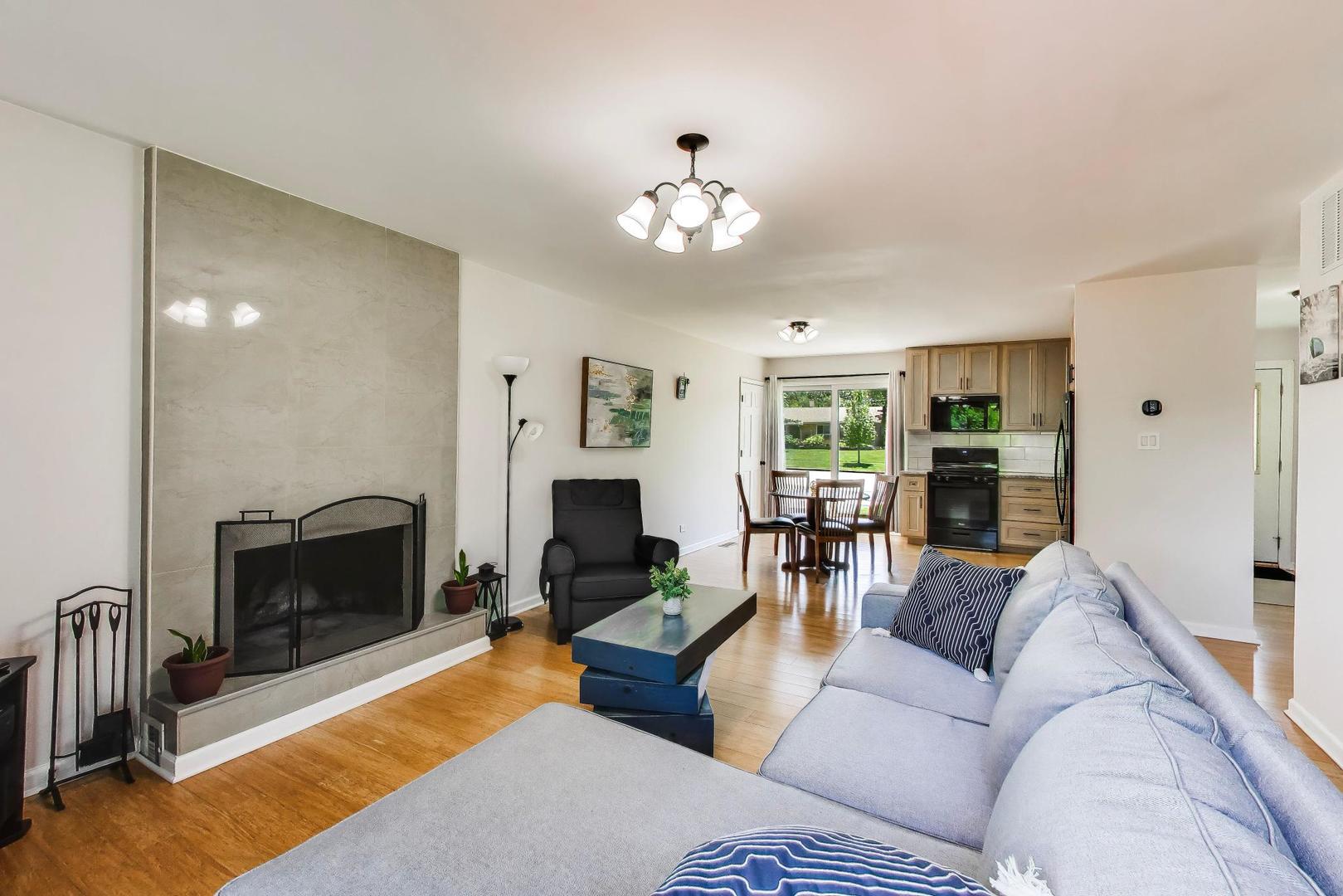 420 Bode Road Hoffman Estates, IL 60169 - Photo 5 of 20 a living room with furniture a fireplace and a flat screen tv