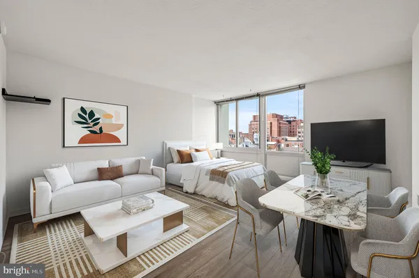 a living room with furniture a large window and a flat screen tv