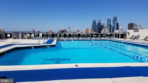 a view of a swimming pool with outdoor seating and yard