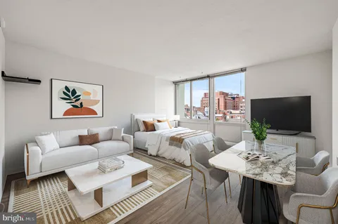 a living room with furniture a large window and a flat screen tv