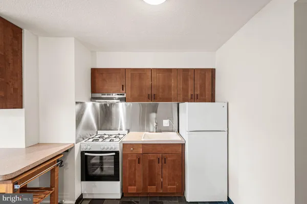 a kitchen with a refrigerator and a stove
