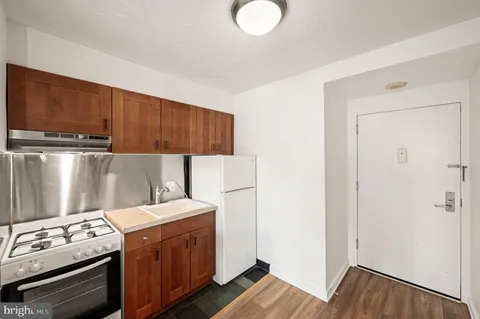 a kitchen with a stove top oven a sink and a microwave