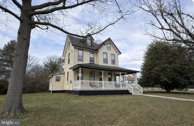 a view of a house with a garden and deck
