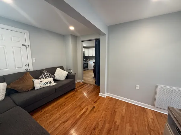 a living room with furniture and wooden floor