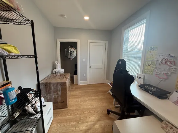 a bedroom with furniture and a window