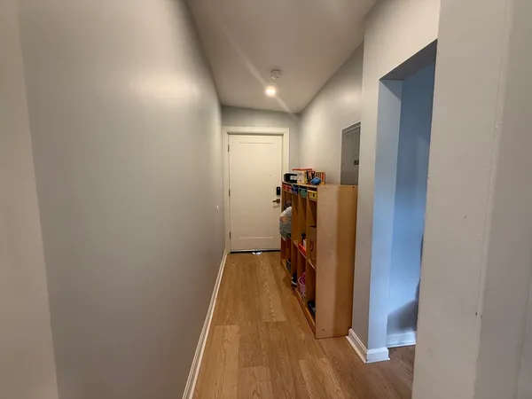 a kitchen with sink a refrigerator and chairs