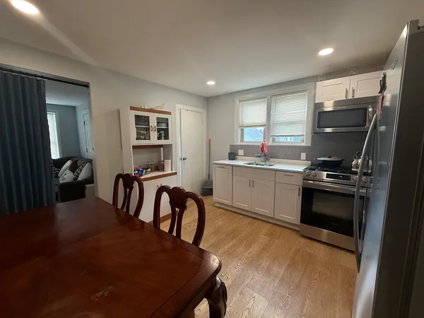 a kitchen with refrigerator cabinets and chairs