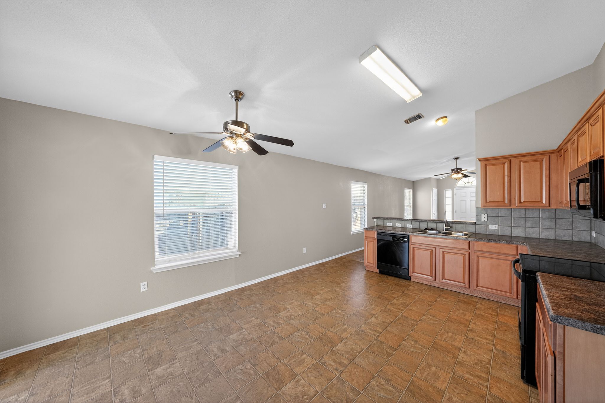 1007 Gentry Drive Leander, TX 78641 - Photo 35 of 35 a large kitchen with kitchen island granite countertop a stove top oven a sink a window and dining table